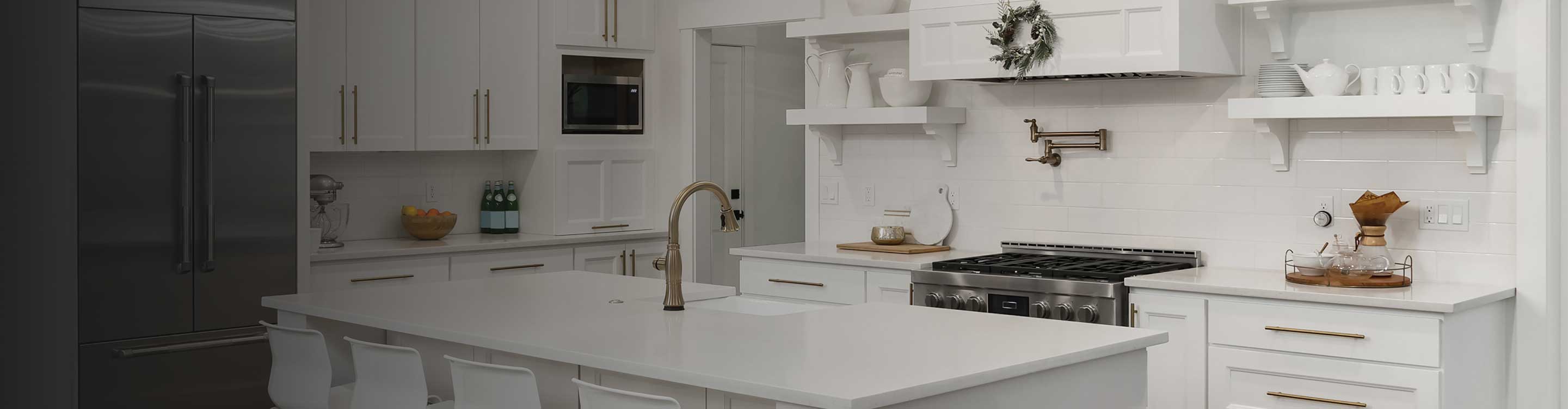 White cabinets with gold hardware in a kitchen.