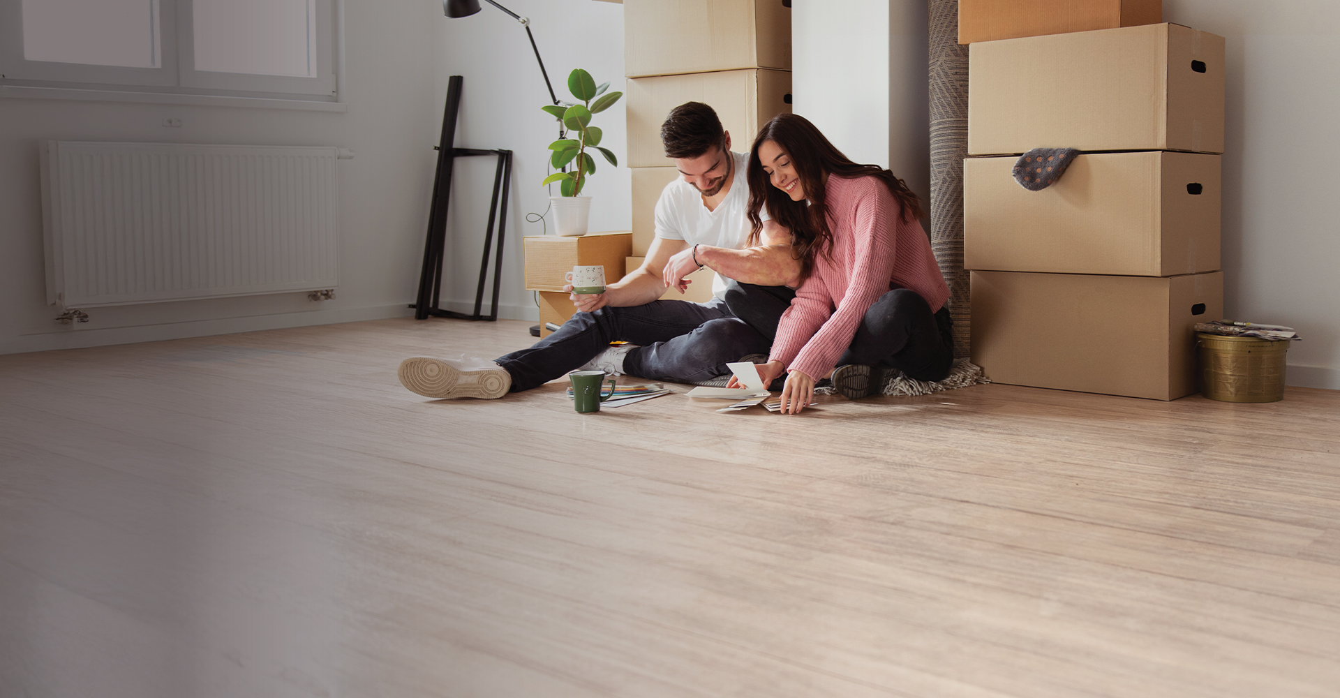 couple sitting on new luxury vinyl floor in kitchen